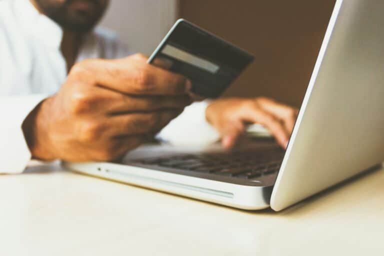Illustrative photograph of a person using a credit card, not a specific card statement