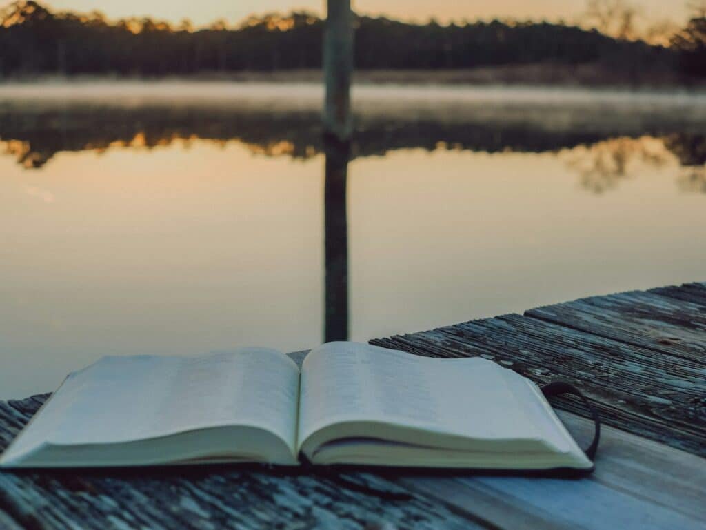 Open book by the water representing reflection and financial independence