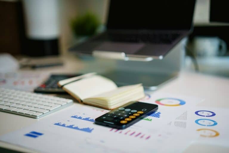 Illustrative photograph of finance reports and a calculator representing business cash flow