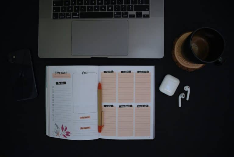 Notebook and coffee used for salary planning