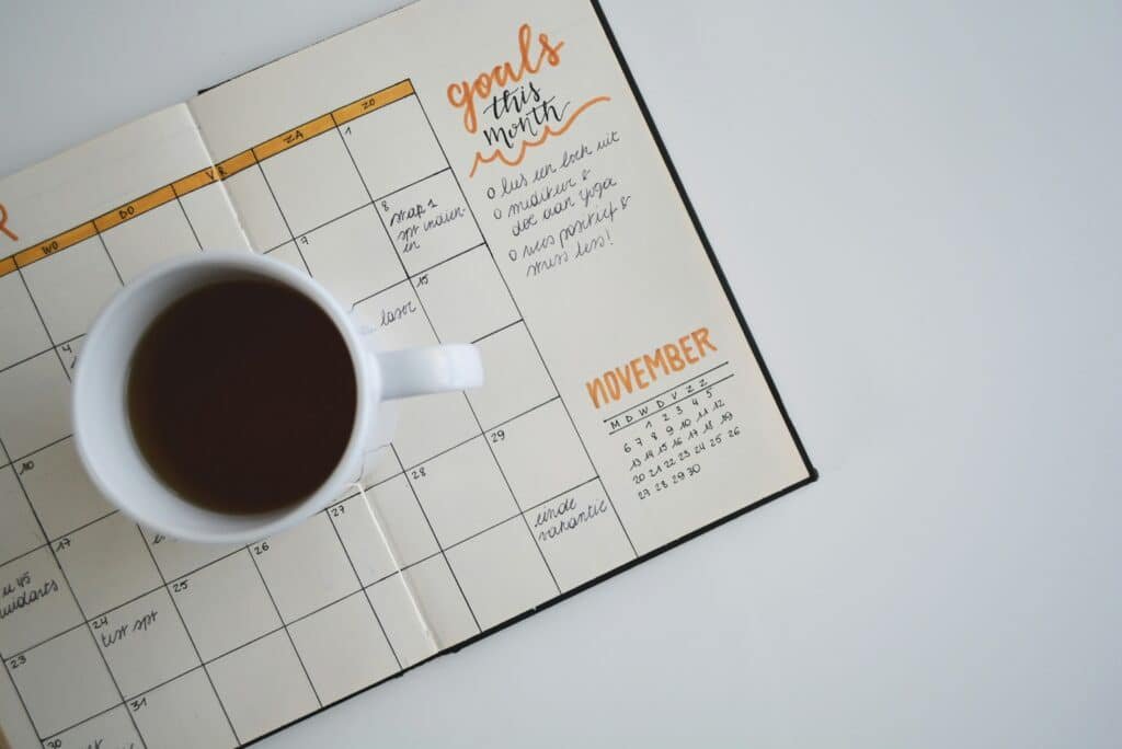 Open planner with a cup of coffee