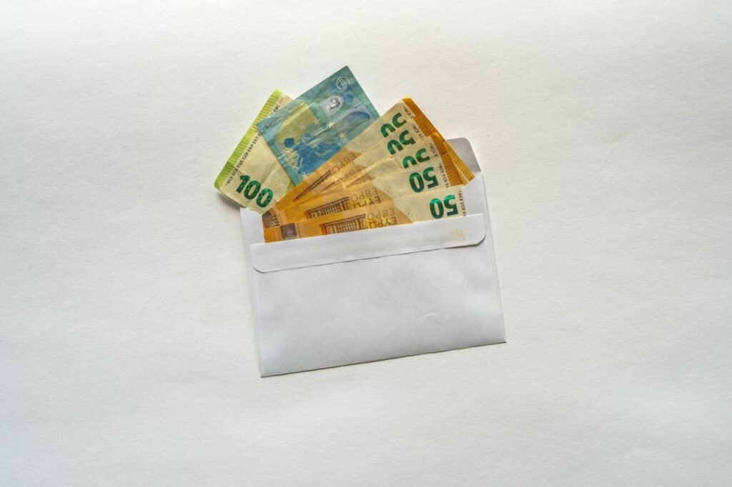 Illustrative photograph of cash and savings envelope for emergency budgeting