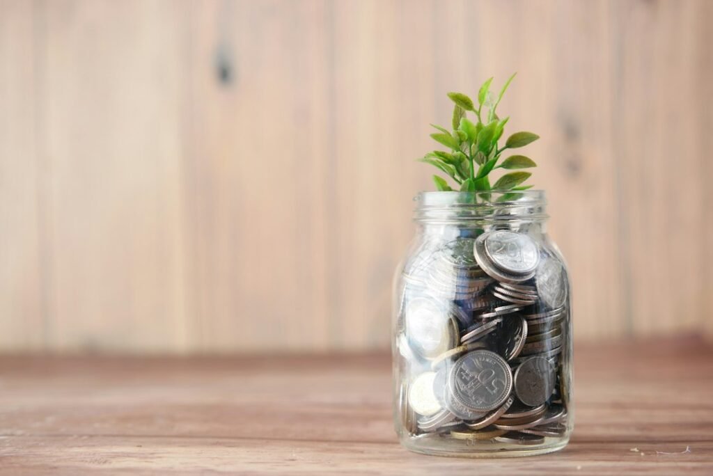 Illustrative savings jar containing coins and a plant, representing the concept of compound growth